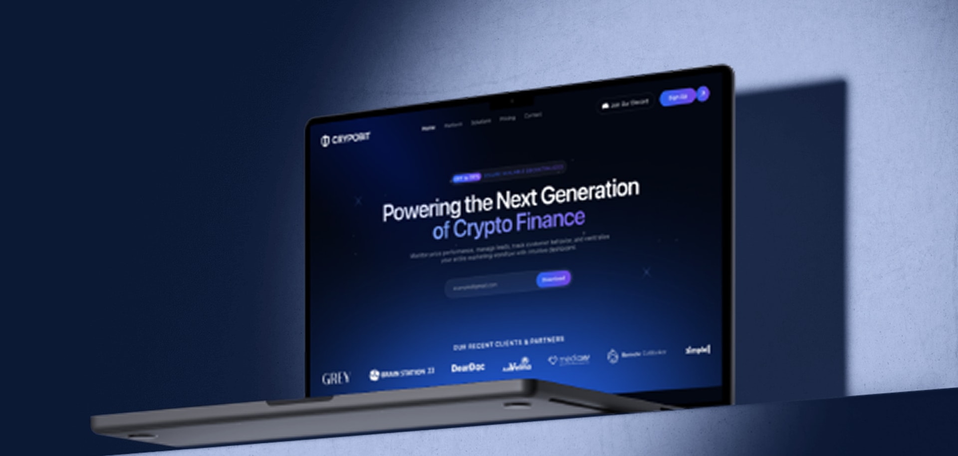The CRYPOBIT trading homepage open on a laptop against a blue wall