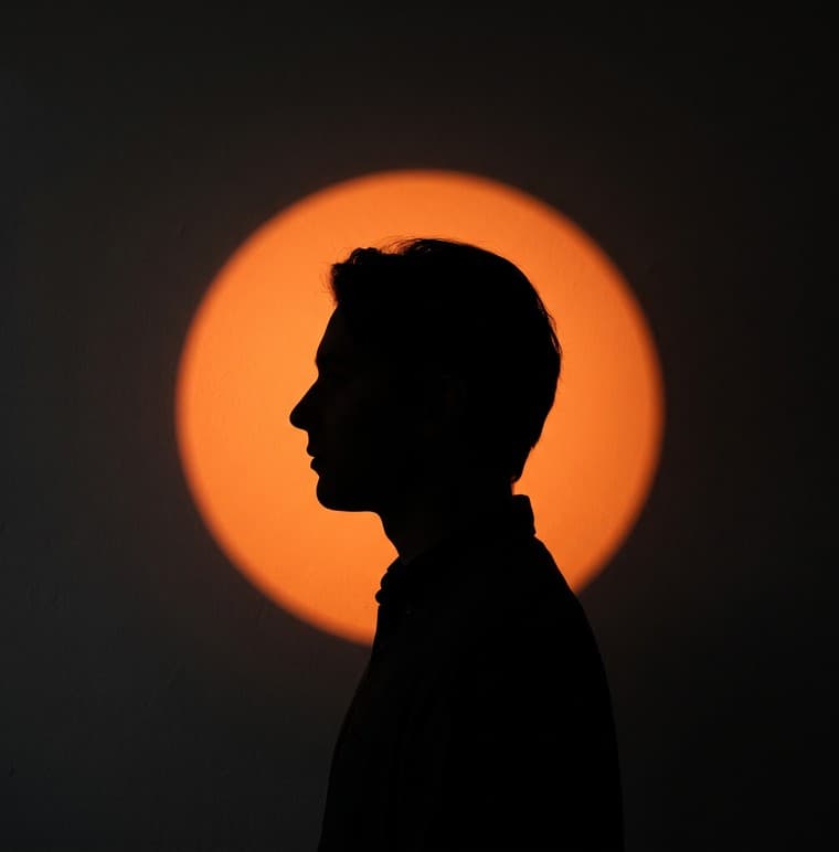 Portrait against an orange spotlight